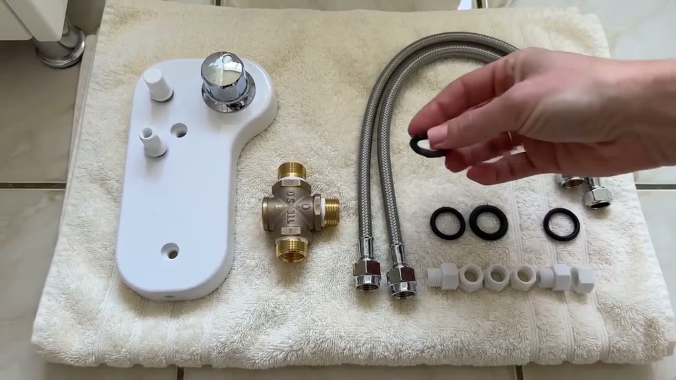 Sample clip poster: hands laying out bidet hardware on a table