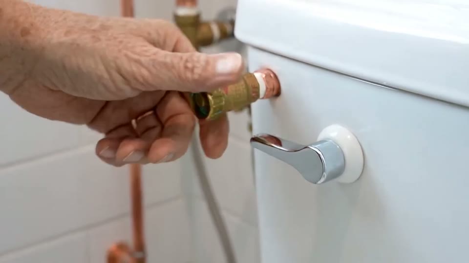 Sample clip poster: hands turning a water valve behind a toilet