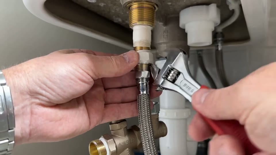 Sample clip poster: hands installing a brass T-valve on a toilet supply line